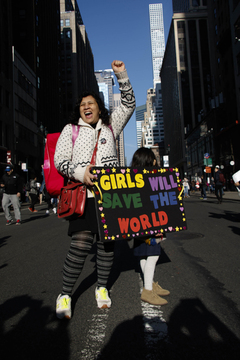 A mother and daughter march in New York City, where about 250,000 protesters gathered.