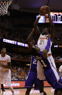 Sophomore forward Tyler Roberson bowls over Powers for what turned out to be a three-point play down the stretch. 