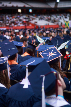 On this student's cap: a compass pointing northeast. 