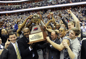 Head coach John Thompson III and Markel Starks cheer with teammates as they hold up the Big East regular-season championship trophy.