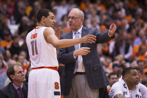 Syracuse head coach Jim Boehiem instructs freshman point guard Tyler Ennis.