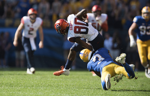 Taj Harris is tackled by a Pittsburgh defender.