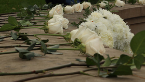 People gather at the Rose Laying ceremony to acknowledge the lives of the victims and act forward in their memory.