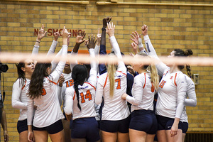 Syracuse huddles and throws its hands in the air.