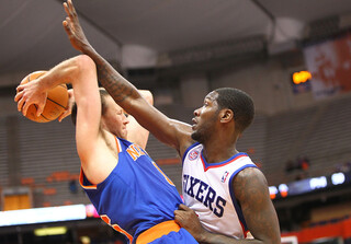 Steve Novak of the New York Knicks reaches back to maintain posession against Royal Ivey of the Philadelphia 76ers.