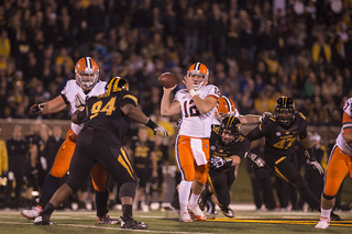 Syracuse quarterback Ryan Nassib looks for a place to throw downfield while trying to avoid pressure.