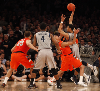 (Right) Georgetown's Otto Porter (#22) fights for one of Georgetown's last plays before the end of overtime.