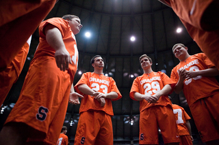 (From left) Ferrigan, Scott Firman and Jimmy Wyrick gather in a circle.  