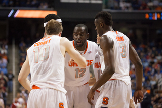 Keita rallies his teammates as the Orange huddles late in the second half.