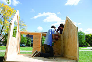 Serena DeSeta, a freshmen dual public relations and management major, and Sam Sinykin, a communication and rhetorical studies major, work on the Orange Seeds shack, a freshman leadership program on campus.