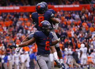 Safeties Kelly and Ritchy Desir celebrate a defensive stop. 