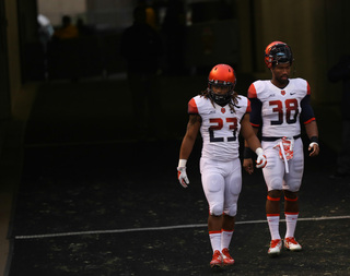 SU seniors Prince-Tyson Gulley (23) and Cameron Lynch (38) look on at Heinz Field.