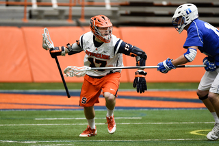 Dylan Donahue tries to evade a Blue Devils close defender. The junior logged seven points, including five goals and two assists.