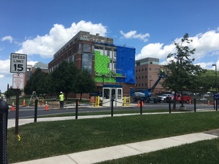 Construction on the Life Sciences Complex continues as workers repair the siding on the south side of the building. The mechanical penthouse on the roof will also be replaced, according to the project description. Photo taken June 8, 2016