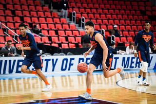 Moyer, Battle and Howard run a drill together during practice.