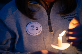 Remembrance Scholars wear buttons with the names and images of the students they represent. 