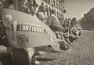 Fans hold their NCAA championship pennants at the celebration parade held for the Syracuse Orangemen on Saturday, April 12, 2003. The parade traveled down Salina Street and ended in Clinton Square.